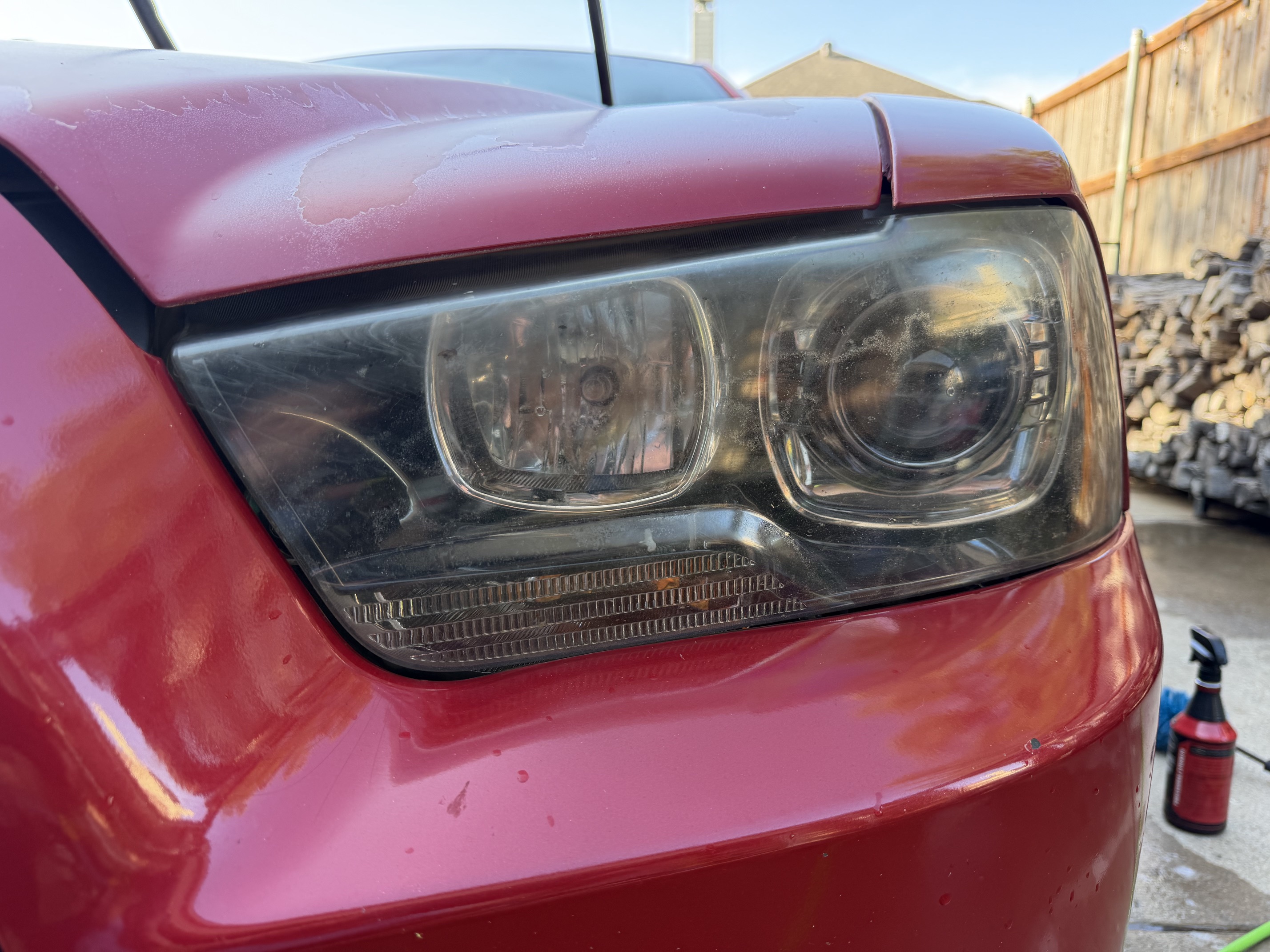 Cloudy Dodge Charger driver headlight before restoration